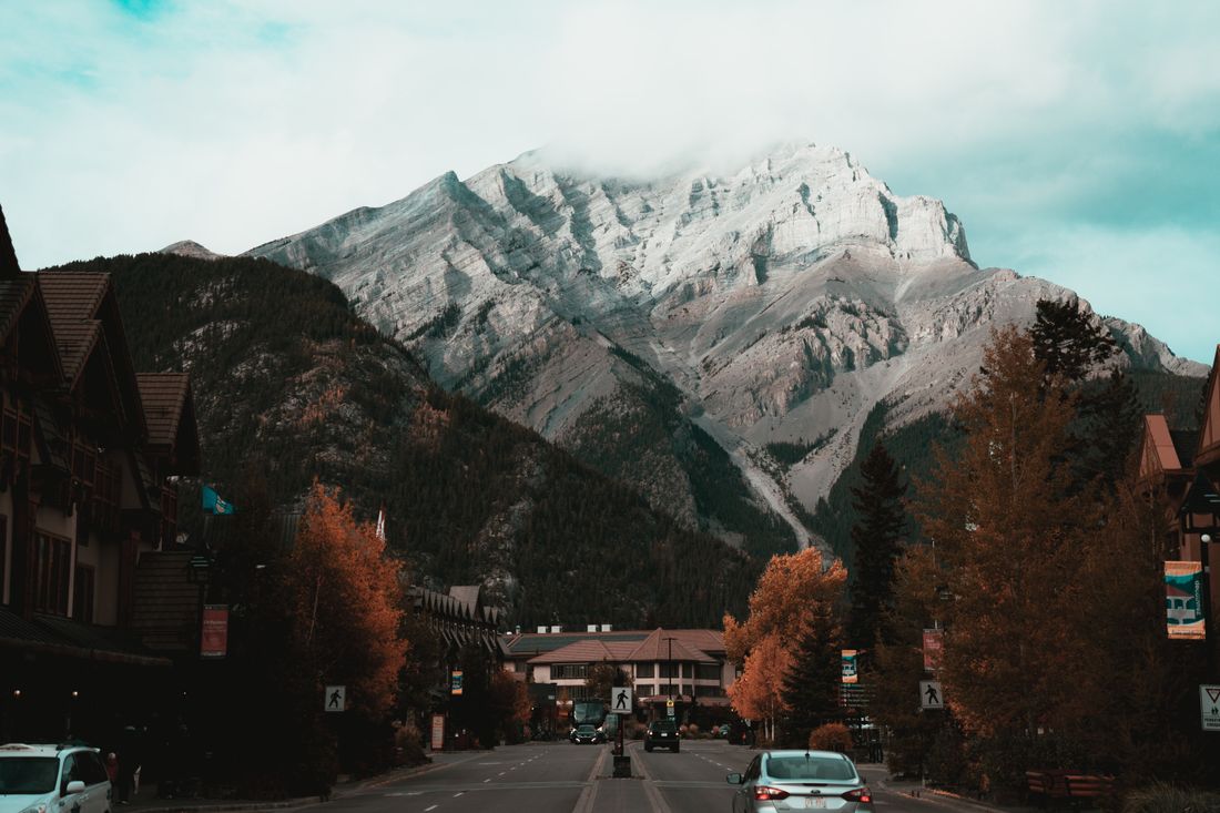 A mountain town main street beneath a snow-dusted peak